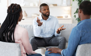 A man explaining something to a couple