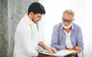 Doctor showing records to a patient